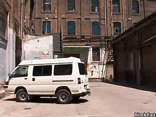 Blonde tied tight in latex endures outdoor public domination play