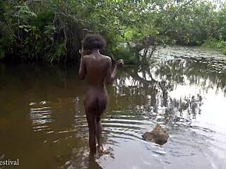 cute african village girl bathes naked by the river