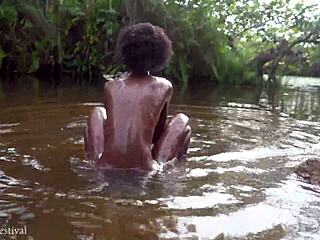 cute african village girl bathes naked by the river