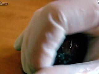 she grabs those gloves and strokes the massive black dildo close-up pov till it's throbbing wet and ready