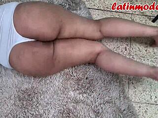 Sexy latina stuns in white outfit with curves and teasing pose