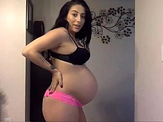 Cute Pregnant Woman Displays Her Sexy Round Belly