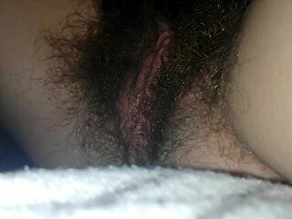 bedside close-up of hairy wet pussy clit vibrating to intense orgasm