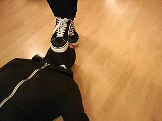 Mistress makes him devour treats beneath her worn sneakers