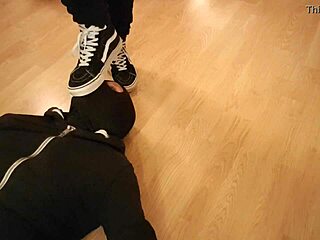 Mistress makes him devour treats beneath her worn sneakers