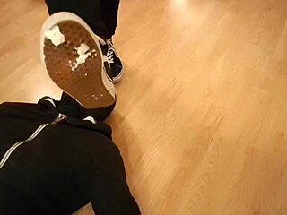Mistress makes him devour treats beneath her worn sneakers