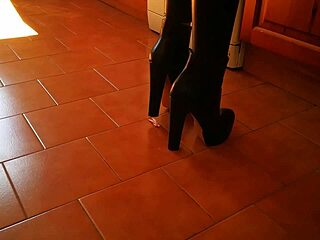 towering mistress in heels and boots dominates slave hard in the garage