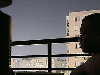 Amateur couple relaxing together on balcony