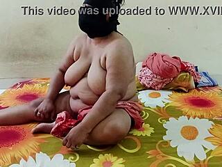 attractive indian bhabhi stands in the village ranch area